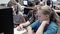 Teacher is working with the students in a classroom