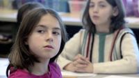 Students is paying close attention to a teacher in a classroom.
