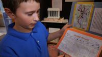 A student is showing his Ancient Greece history report.