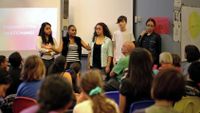 A group of students are having a presentation in front of the classroom.