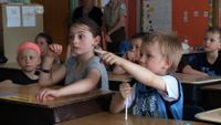 Student answered to the teacher in a classroom.
