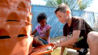 Students are planting in the school backyard.