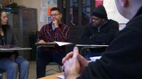 A group of students are having a group meeting.