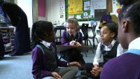Primary students are talking in a group work together