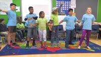 A group of students are having fun in a classroom.