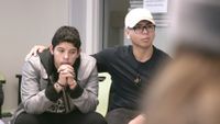 photo of two students, one with his arm around the other in a supportive manner