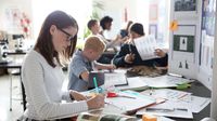 Middle school students working on science project in classroom.