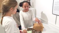 Two third grade girls from Friends School of Baltimore discuss a project about Native Americans.