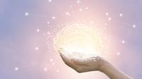 Hands holding illuminated illustration of a brain