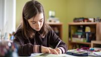 Adolescent girl doing homework.