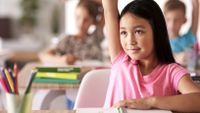 Girl raising hand in class.