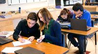 Teenage students working in pairs on a class assignment.