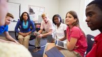 Students sitting in a circle, discussing their reading assignment