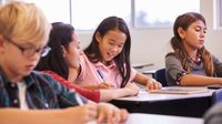 Teacher connecting with a student personally in a classroom
