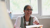 Teacher smiling at her desk
