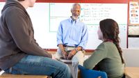 Teacher and students talking in the classroom.