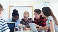 Group of teenage students working together on a design project