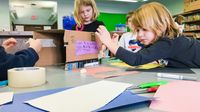 Students making a prototype for a penguin nesting box as part of a maker project