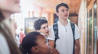 A group of middle school students looking at a bulletin board