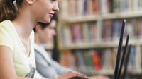 Students use laptops in the library