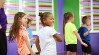 A group of students taking a break in the classroom to get up and move around