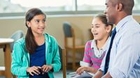 A teacher talks to a group of students
