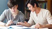 Two high school students annotating a text