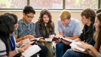 A group of high school students sitting in a circle, discussing a book