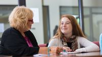 A teacher and a student conferencing together