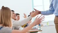 A teacher high-fiving his students