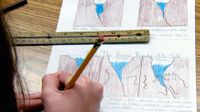Close up of a hand holding a pencil captioning drawings of water seeping between rocks, freezing and melting