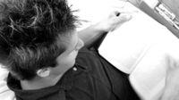 A person is sitting on a bean bag chair, reading.
