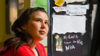 photo of a student in front of a presentation board about genius hour