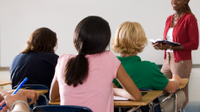 photo of teacher in front of an engaged classroom