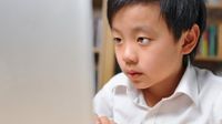 Young boy in front of computer