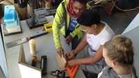 A photo of 3 high school girls working in the makerspace.
