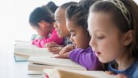 photograph of elementary school students reading from books