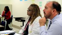 A principal and two teachers listening