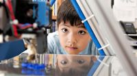 Boy looking at a printer