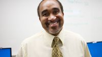 Standing, smiling man in tie