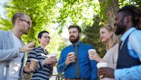 A group of teachers chat over coffee.