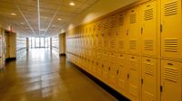 School corridor with yellow lockers lining both sides