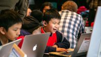 A roomful of kids design games around real-world problems.