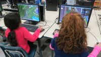 Kids explore Minecraft in a class.