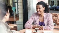 Two educators take time to relax over a cup of coffee.