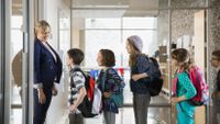Students line up in front of classroom.