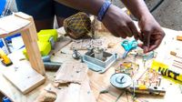 Girl working at a plywood table covered with materials