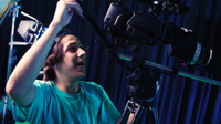 Boy filming using a very large camera