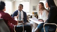 Teachers and a parent discuss a student’s Individualized Education Program.
