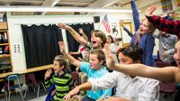Vermont students wave to Korean students during a virtual presentation.